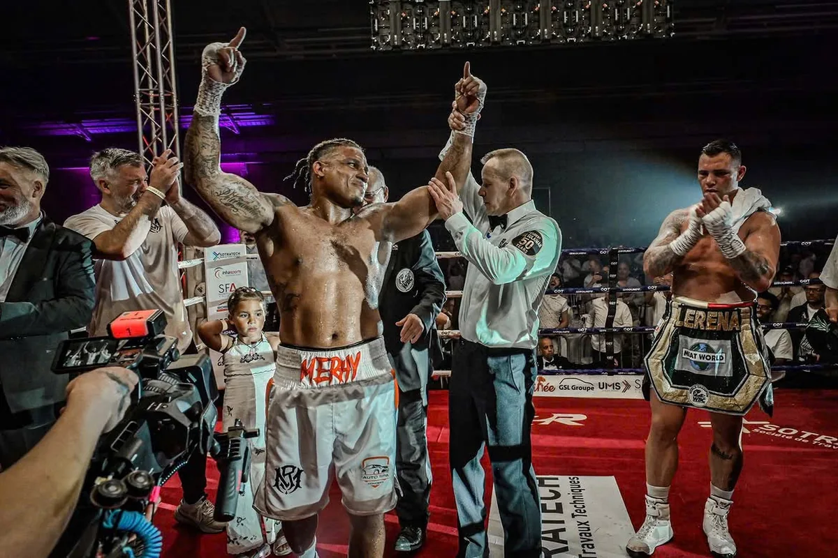 Ryad Merhy with his hand raised by the referee after a win