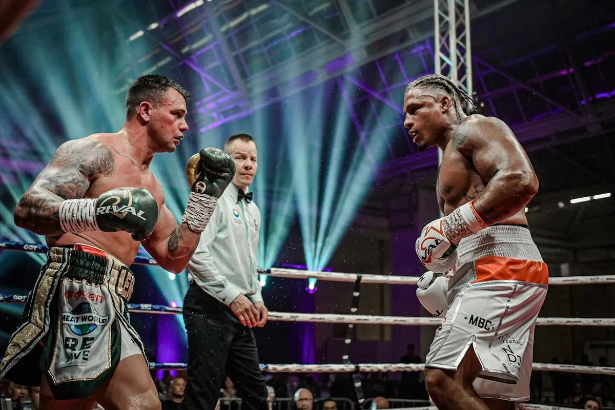 Ryad Merhy facing an opponent across the ring